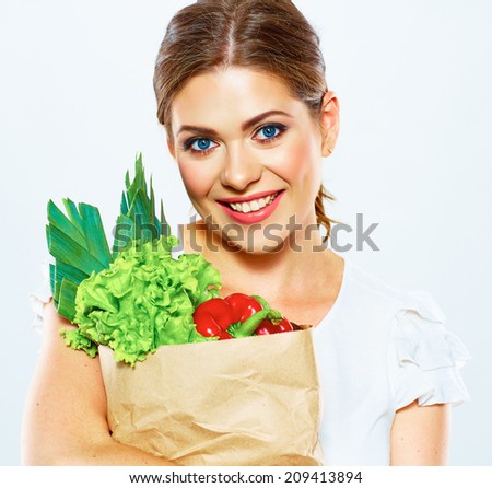 Smiling woman hold bag with green food. Vegan lifestyle. Close up portrait.