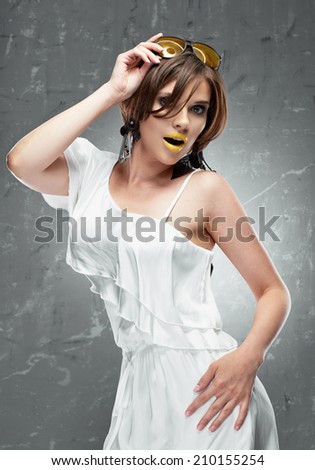 Fashion model woman, yellow sunglasses, white cocktail dress.