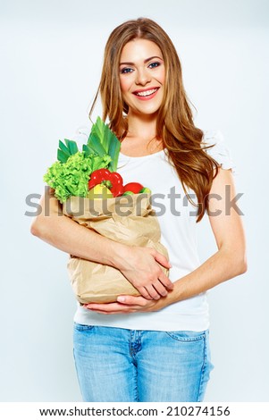 woman hold shopping bag with green vegan food. white background .