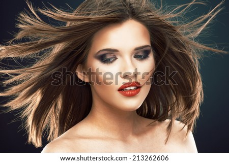 Hair style smiling woman portrait. Beautiful model  with long blowing hair.