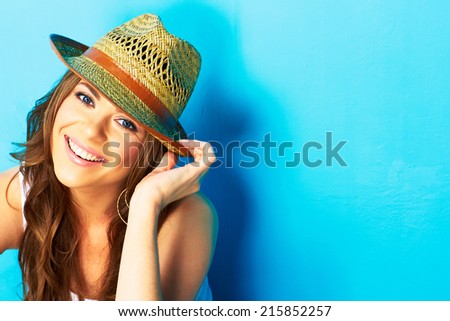 beautiful woman with straw hat smiling and happy . blue background .