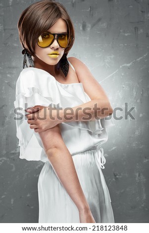 Fashion model woman, yellow sunglasses, white cocktail dress.