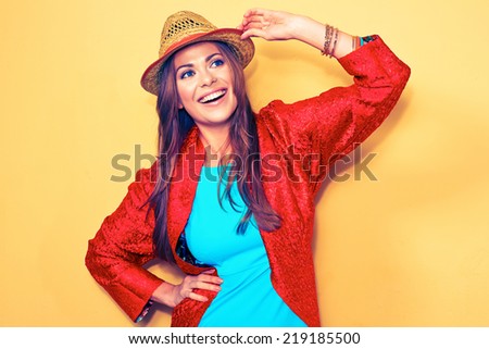 smiling woman fashion style portrait. blue dress. red cape.