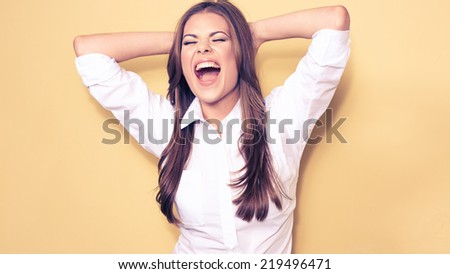 happy emotional business woman portrait . smiling model, white shirt. yellow background.