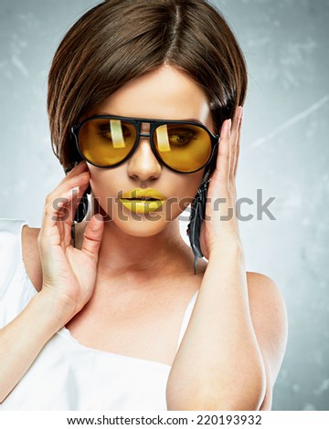 Young woman beauty portrait with yellow sun glasses. Face. Beautiful model.