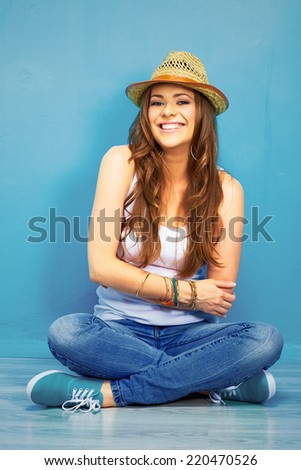happy woman full body portrait . girl sitting on a floor in teenager style