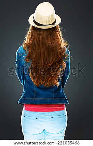 woman standing back against gray background . isolated .