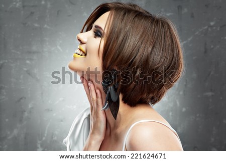 smiling young woman with bob haircut. profile view. beauty face . short hairdress.