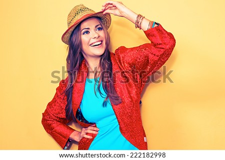 happy young female model. smiling woman fashion style portrait. blue dress. red cape.