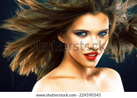 Portrait of beautiful smiling woman with long blowing hair. Hair style portrait.