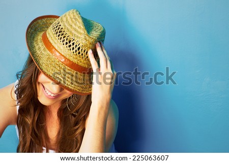 Beautiful modern style woman looking down . face portrait . yellow hat .