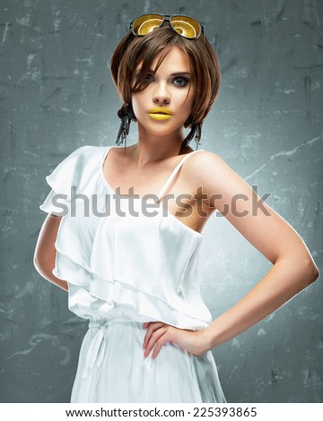 Fashion model. White dress. Yellow lips, sunglasses.
