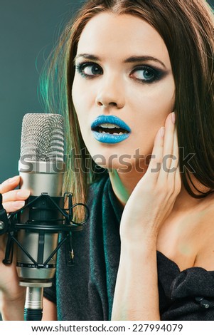 Close up beautiful woman singer portrait. Sound studio.
