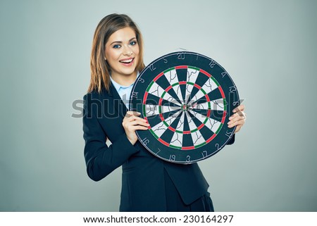 Business woman smiling and holding big target of darts. Success concept portrait.