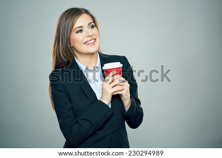 Business woman dressed office style suit smiling and hold red cup of hot drink. Isolated business portrait.