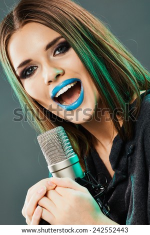 Woman microphone singing. Beauty model sound studio posing.