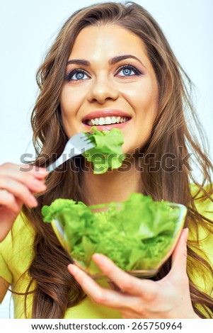 woman eating salad. close up face portrait of smiling woman. green vegan diet.