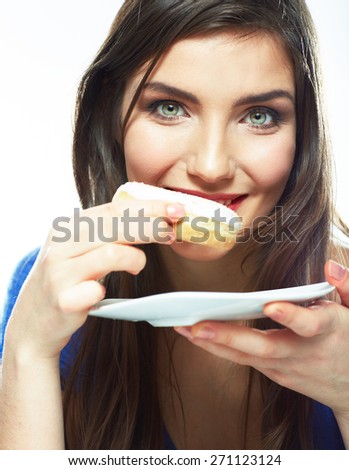 Woman bite donut. Close up portrait of young woman holding plate with donut.