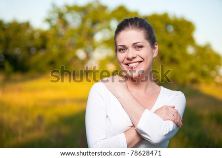 Young woman portrait on summer tree background. Outdoor portrait