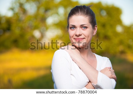 Woman on summer tree background. Outdoor portrait with big smile.