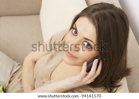 smiling woman speaks by phone