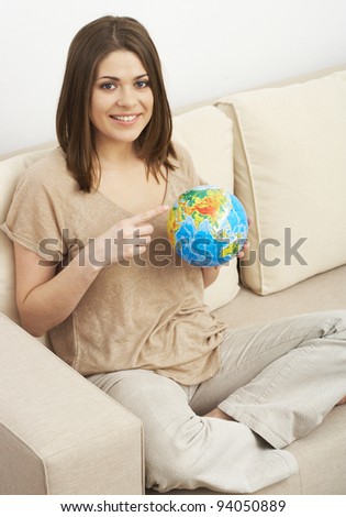 Portrait of woman searching something on the globe