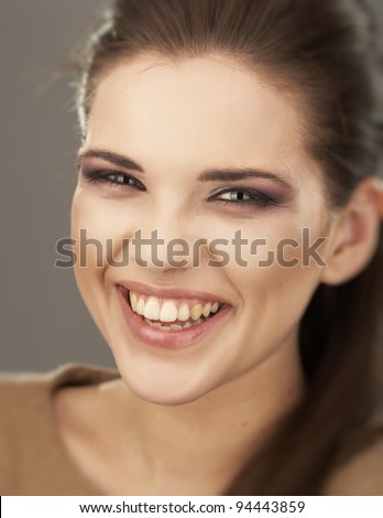 Young woman portrait with toothy smile. Closeup