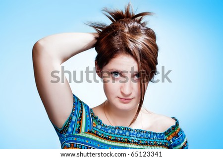 Attractive young caucasian women holds hair in hand.