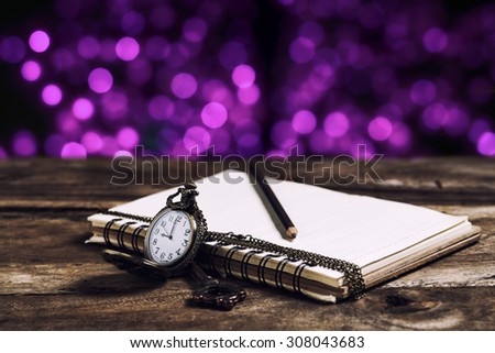 books and vintage clock with blur bokeh light in city background ,vintage tone