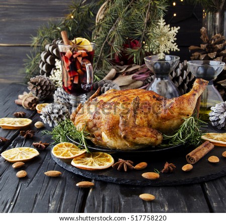Roast chicken or turkey for Christmas and New Year with mulled wine and Christmas decorations, selective focus