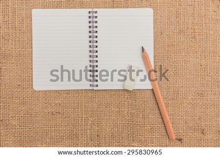 note book ,pencils,eraser on sack background