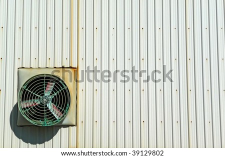 Fan on industrial building exterior