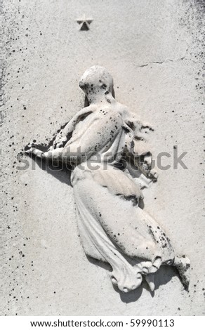 Female figure and star bas-relief on weathered nineteenth century gravestone