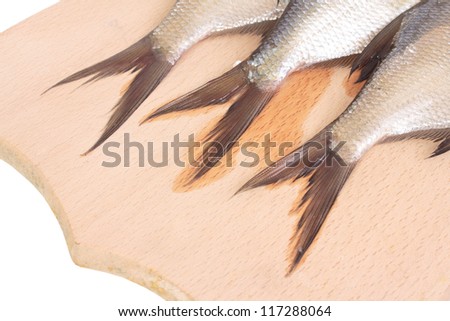 Fish fry on a wooden board. Isolated on white