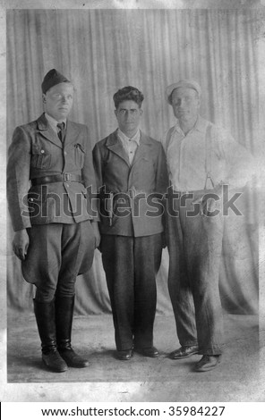 Portrait of three men, two soldiers and one civilian. The Second World War