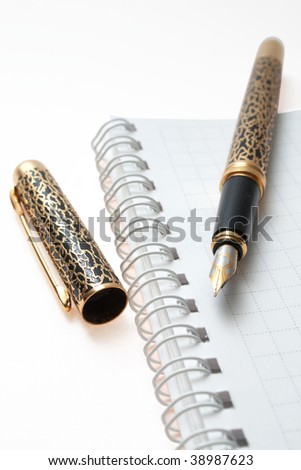 business organizer, notebook or planner with gold pen