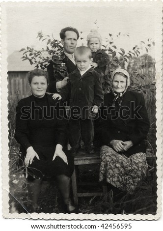 Soviet family. Man with a wife and an old woman (grandmother), and with their children: a boy and girl USSR, mid 20 century