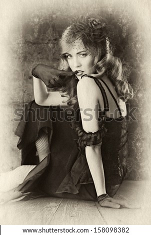 black and white vintage portrait on retro background. woman biting her finger.