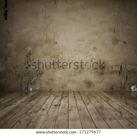 old room with concrete wall and wooden floor