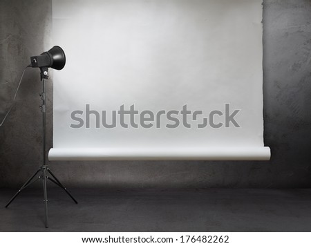 Photo Studio In Old Grunge Room With Concrete Wall And Paper Background
