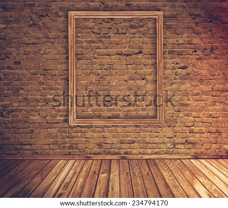 old grunge interior with blank picture frame against wall, retro film filtered, instagram style