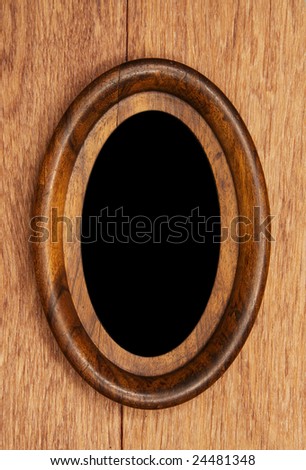 vintage oval photo-frame on wooden background