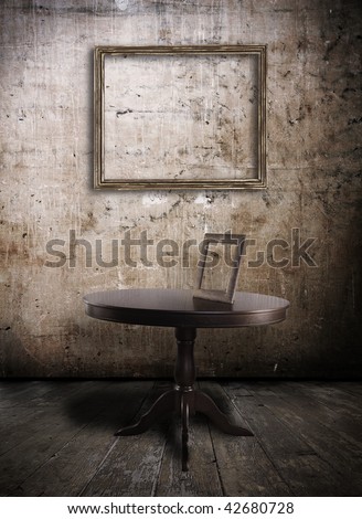 table and old photo-frame in grunge interior