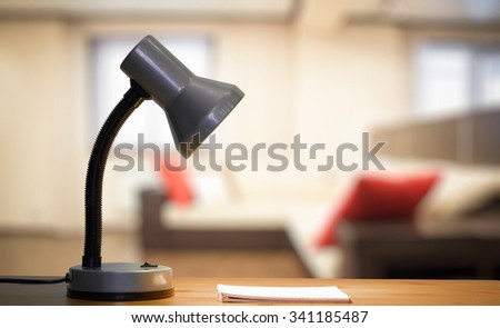 lamp and notebook on table in the living room