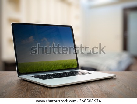 laptop on old wooden table in the bedroom