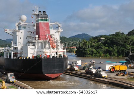 Ship in the Panama Channel Lock centered by the locomotive