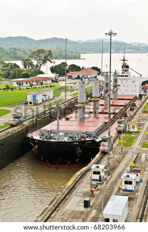 Ship in the Panama Channel Lock centered by locomotives