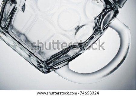 Detail of a beer glass horizontal on a plain white background