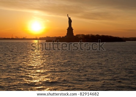Statue of Liberty with setting sun on the left,New York City,New York