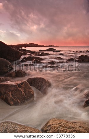 Ocean rolling over rocks at sunset
